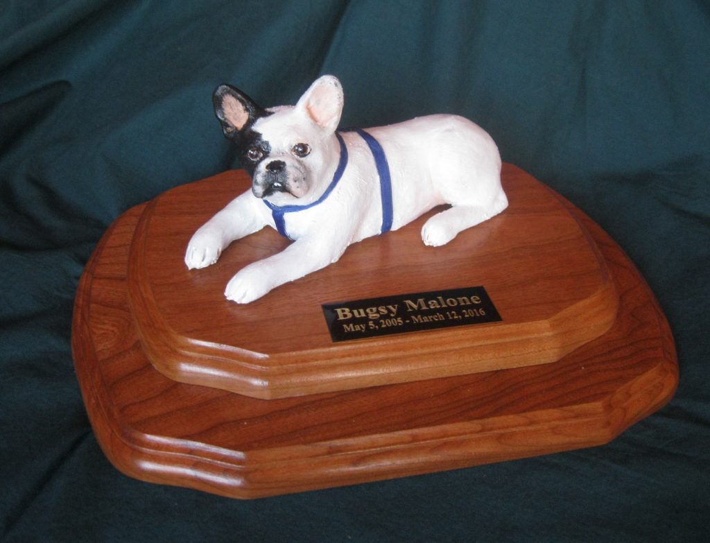 A custom dog statue of "Brandy" with his tennis ball.